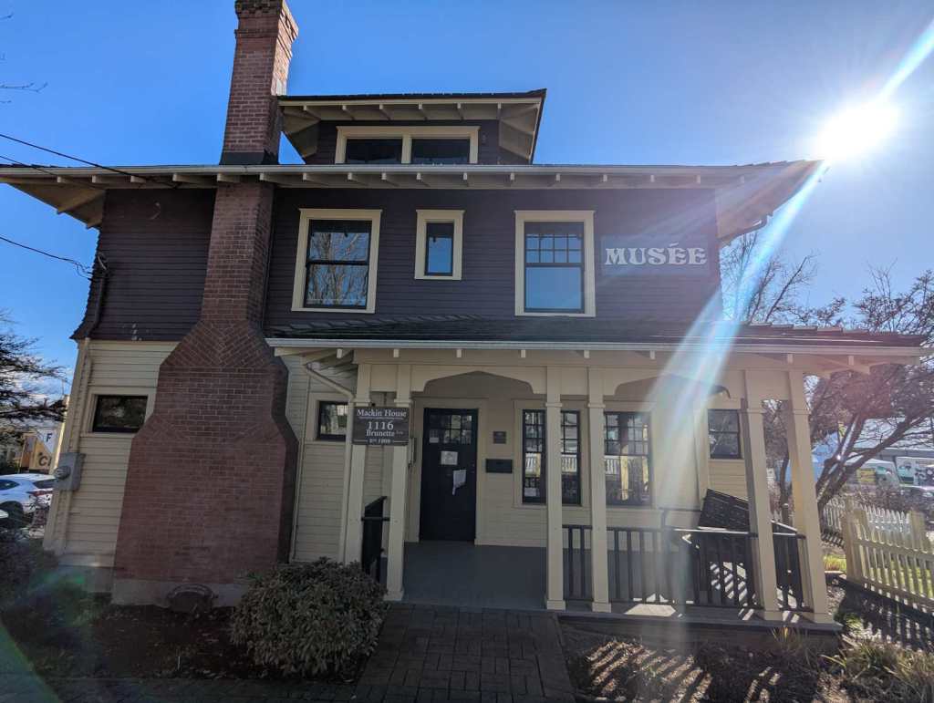 Ein denkmalgeschütztes Haus, das heute ein Museum beherbergt. Es besteht aus hellem Holz im Erdgeschoss, rotem im Obergeschoss. Links ist ein großer Kamin asus roten Backstein, der das Haus überragt. Es gibt eine große Veranda vor dem Haus und im ersten Obergeschoss ist ein Schild mit der Aufschrift "Musée". Ein denkmalgeschütztes Haus, das heute ein Museum beherbergt. Es besteht aus hellem Holz im Erdgeschoss, rotem im Obergeschoss. Links ist ein großer Kamin asus roten Backstein, der das Haus überragt. Es gibt eine große Veranda vor dem Haus und im ersten Obergeschoss ist ein Schild mit der Aufschrift "Musée".